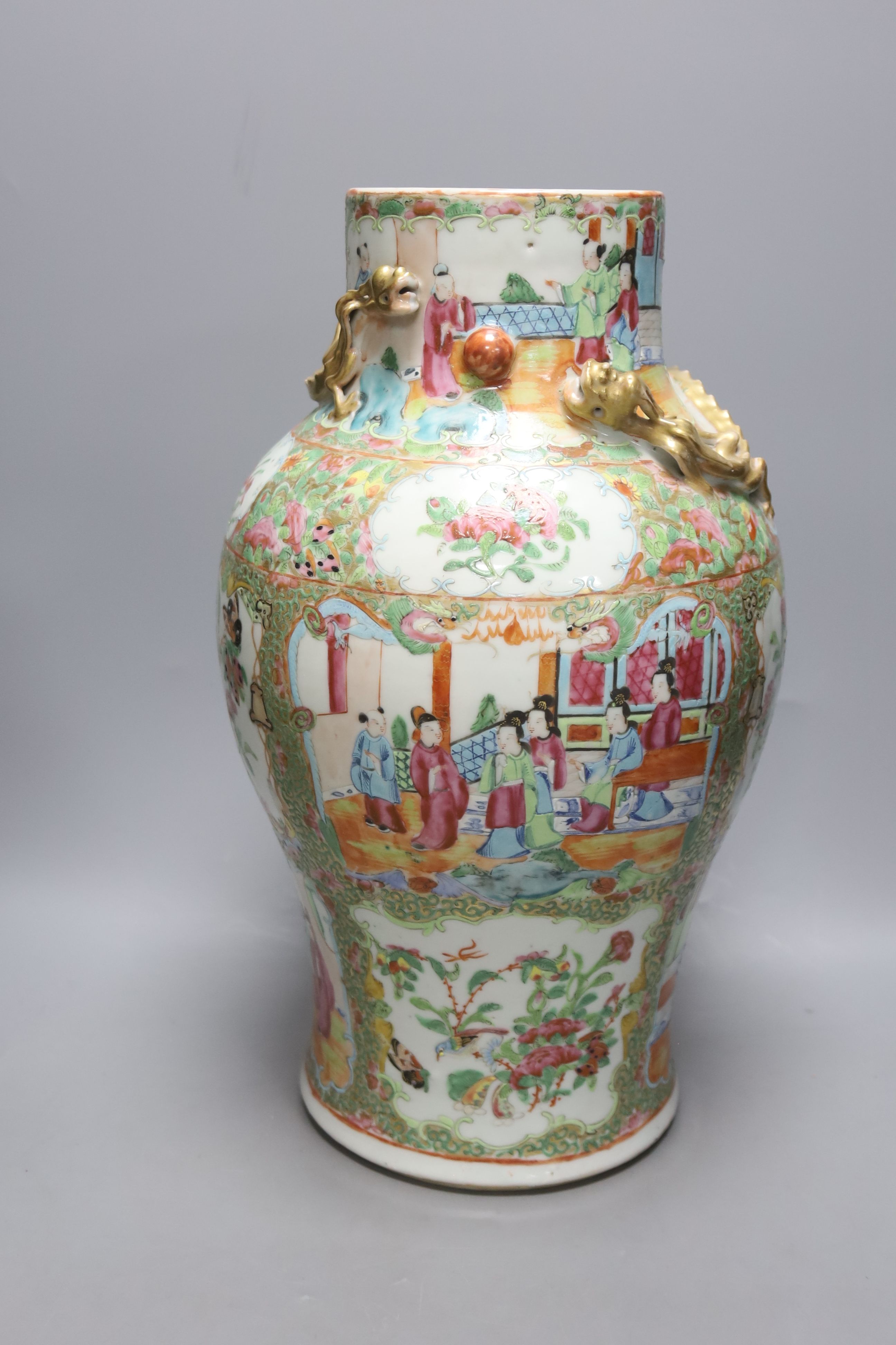 A pair of 19th century Chinese famille rose vases, height 30.5cm and a similar larger vase, 37.5cm (3)